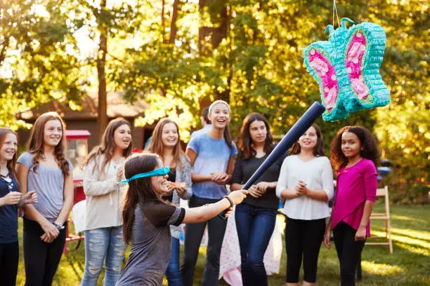 friends-watch-a-young-girl-hitting-a-pinata